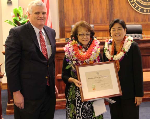 Chief Justice Mark Recktenwald (left) and Associate Judge Lisa Ginoza (right) congratulate Hattie Embernate, Fiscal Office, Office of the Court Administrator, Third Circuit (center), recipient of the Judiciary’s 2015 Distinguished Service Award 