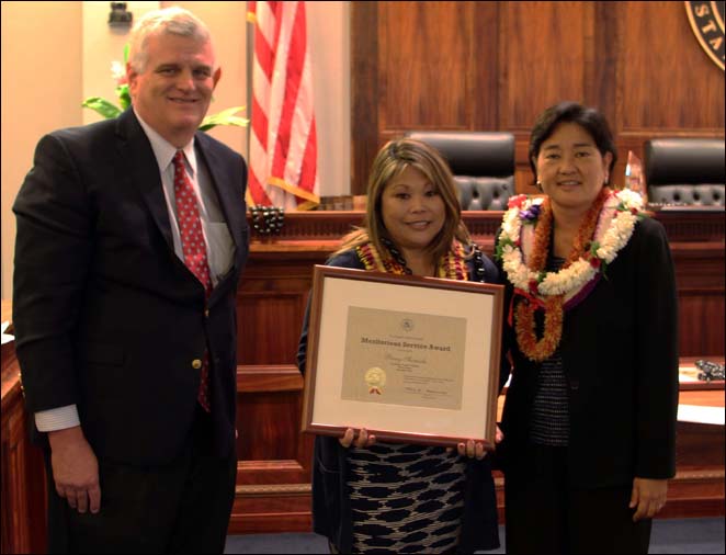 Chief Justice Mark Recktenwald (left) and Associate Judge Lisa Ginoza (right) confer the Judiciary’s  Meritorious Service Award to Penny Shimada, Court Operations and Support, Family Court, Second Circuit (center)