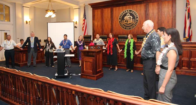 Speakers join hands to sing the Hawai`i Pono'i