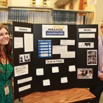 Two law library staff stand next to Law Day 2016 Miranda More Than Words display