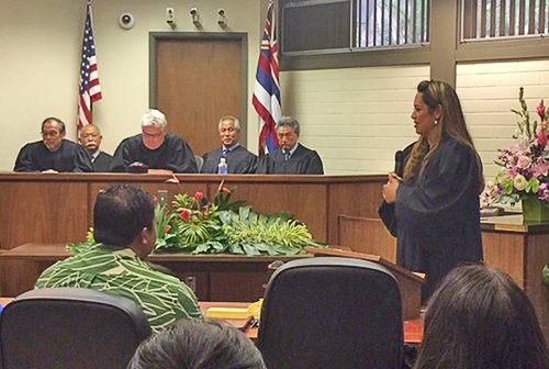 Judge Laubach stands and addresses the court.