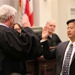 Chief Justice Mark Recktenwald adinisters the oath of office to James Kawashima.