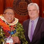 First Circuit Chief Judge Derrick Chan with Chief Justice Mark Recktenwald in front of the Supreme Court seal.