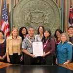 Hawaii Governor David Ige holds proclamation surrounded by 9 alternative dispute resolution practitioners.