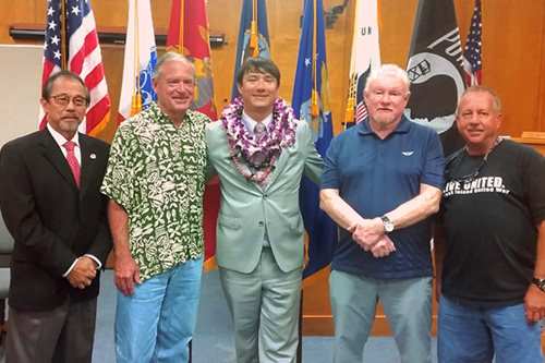 Photograph celebrating the third graduate of the Kona Big Island Veterans Treatment Court .