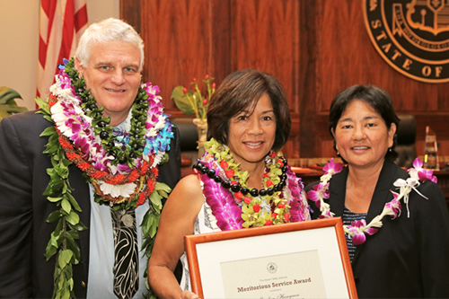 Chief Justice Mark E. Recktenwald and Associate Judge Lisa Ginoza confer the Judiciary's Meritorious Service Award.