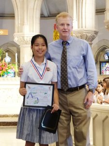 2018 First Circuit Law Day Art contest winner in the Fourth-Fifth grade category, Juliana Shi (second place) of  St. Andrew's School, is pictured here with Chief Judge R. Mark Browning.