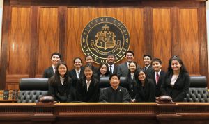 Photo of Internmediate Court of Appeals Chief Judge Lisa M. Ginoza and the Pearl City High School White team.