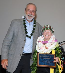 Photo of Steve Holmberg, MCP’s board president, presents Dee Dee Letts with a Champions Award.