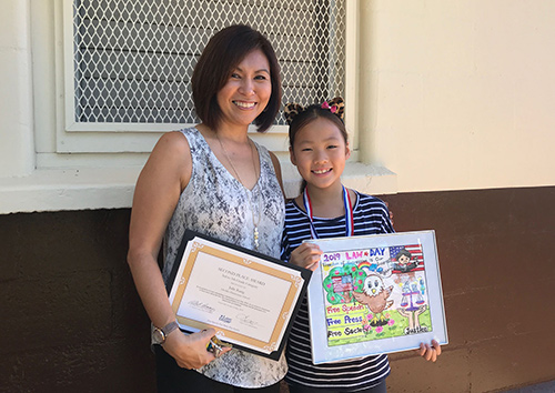 2019 First Circuit Law-Day Poster Contest Second place winner Julie Kang with her teacher Lisa Darcey at Liholiho Elementary award ceremony.