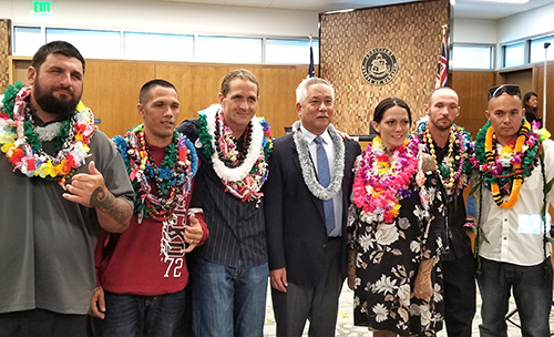Judge Melvin H. Fujino in his courtroom at the Keahuolu Courthouse in Kona with six Big Island Drug Court graduates at the 49th graduation ceremony, October 7, 2019.