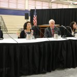 Hawaii Supreme Court Associate Justice Richard W. Pollack, Associate Justice Paula A. Nakayama, Chief Justice Mark E. Recktenwald, Associate Justice Sabrina S. McKenna, and Associate Justice Michael D. Wilson sitting at a table in the gym at Waipahu High School's Courts in the Community event, 11/14/2019.