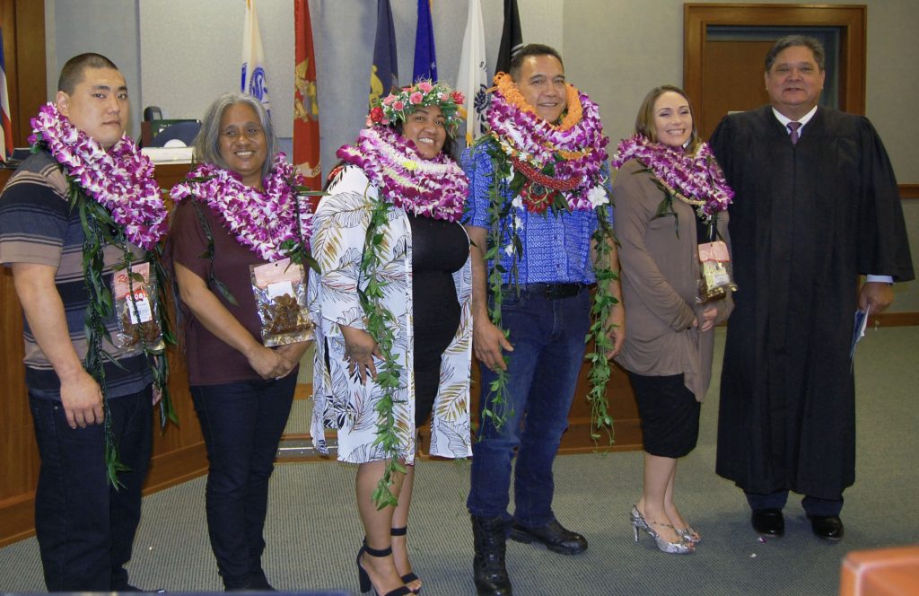 Photo of Judge Michael K. Soong, far right, as he congratulates the proud graduates.
