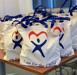 A close-up photo of CASA’s “Aloha WE Care” bags for foster families.