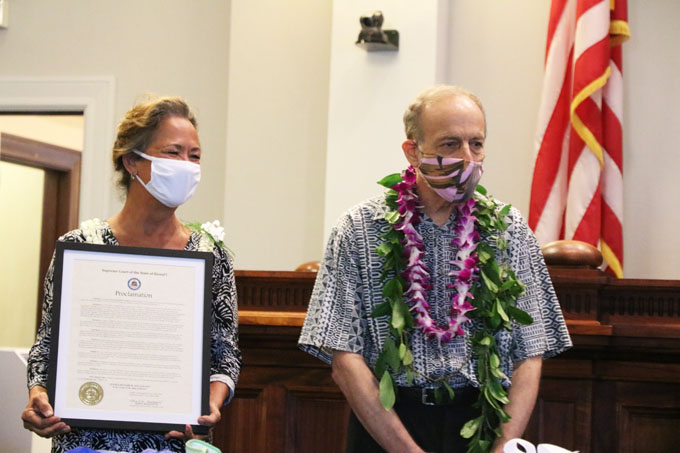 Associate Justice Pollack's wife, Candy, holding the Justice Richard W. Pollack Day Proclamation.