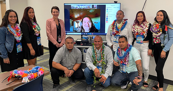 Kona Drug Court Wendy DeWeese and nine graduates, with one appearing on a large screen television, in the Kona courtroom, 05/16/2022.