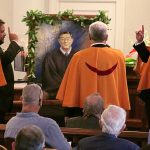 Three members of the Royal Order of Kamehameha I stand in front of a painted portrait of Chief Justice Ronald T.Y. Moon in a ceremonial gesture of tribute, Aug-09-2022.