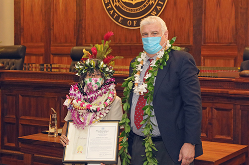 Colleen Masaki, Accountant V, Fiscal Services, Financial Services Department, with Hawaii Supreme Court Chief Justice Mark E. Recktenwald in front of the Supreme Court courtroom bench, 09/23/2022.