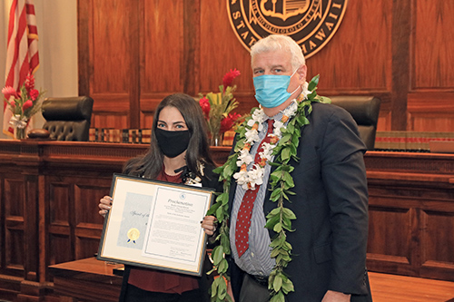 Emily Ovian-Kwiat, Social Worker IV – Drug Court Probation Officer, Kona Drug Court, Third Circuit (Hawaii island), with Hawaii Supreme Court Chief Justice Mark E. Recktenwald in front of the Supreme Court courtroom bench, 09/23/2022.