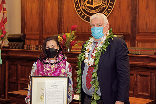 Linda Kawakami, IT Specialist VI, Server Support Section, IT & Systems Department, with Hawaii Supreme Court Chief Justice Mark E. Recktenwald in front of the Supreme Court courtroom bench, 09/23/2022.