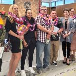 Kona Drug Court Presiding Judge Wendy DeWeese and seven Big Island Drug Court graduates stand together in front of the courtroom bench, 10/24/2022.