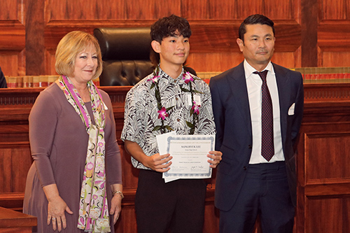 Department of Education Deputy Superintendent Heidi Armstrong, Sanghyuk Lee of Iolani School, and attorney Alen Kaneshiro of the Law Offices of Alen M. K. Kaneshiro stand together in front of the Hawaii Supreme Court bench at the Pro Bono Celebration, 10/27/2022.