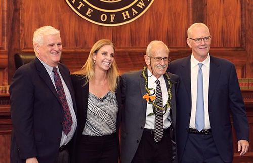 Hawaii Supreme Court Chief Justice Mark E. Recktenwald, Hawaii State Bar Association President Shannon Sheldon, Honolulu attorney William C. Darrah, and Hawaii Supreme Court Associate Justice Michael Wilson stand together in front of the Hawaii Supreme Court bench at the Pro Bono Celebration, 10/27/2022.