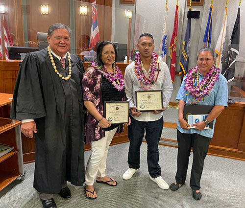 Image of Honorable Deputy Chief Judge Michael K. Soong and graduates Charlene Akau, Brennan Kanahele-Castillo, and Tiana Aguiar.