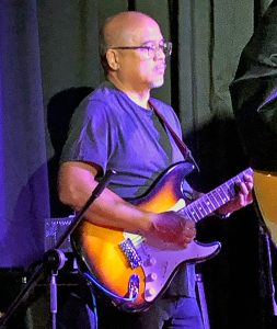 First Circuit District Court Judge William Domingo plays guitar at Rock for Justice at Artistry Kakaako, 11/10/2022