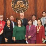 Attorneys and Judiciary staff who provided support for the Kapolei Access to Justice Room stand togther at the front of the Hawaii Supreme Court courtroom, 12/16/2022.