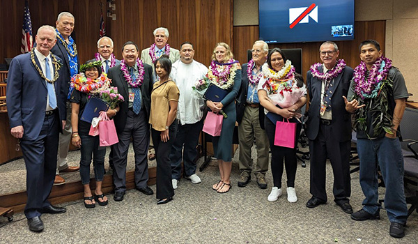 Image of From left, Associate Justice Michael Wilson, Mayor Richard Bissen, Jr., Chief Judge Joseph Cardoza (Ret.), Judge Kelsey Kawano, Judge James Rouse, Chief Judge Shackley Raffetto (Ret.), and Chief Judge Peter Cahill with graduates and a family member.