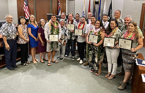 Image of Front, left: Chief Judge Randal G.B. Valenciano; Mia Ako on behalf of U.S. Rep. Jill Tokuda; Dana Hazelton on behalf of Gov. Josh Green; Kauaʻi County Council member Felicia Cowden; Kaipoʻi Pa; Rep. Dee Morikawa; David Bynum; Christian Rapozo; Clarence Ariola (Kaua`i Veteran's Court); Mikayla Nakamura; Mikela Brown; and Sharon Farr. Back, left: Deputy Chief Judge Michael K Soong, Kauaʻi County Council member Addison Bulosan, First Deputy, Office of the Prosecuting Attorney Keola Siu, Judge Gregory H. Meyers, Kauaʻi County Council member Bernard Carvalho, and Kauaʻi County Council Chair and President of the Friends of the Kauaʻi Drug Court and Veterans Court mentor Melvin Rapozo.