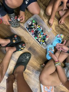 Image of childrenʻs feet and a box of puzzle pieces.