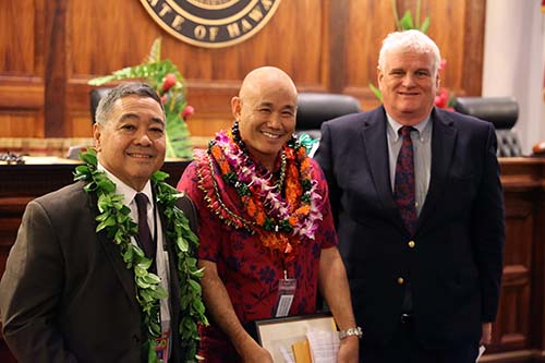 Third Circuit Chief Judge Robert D.S. Kim, Big Island Drug Court Coordinator Grayson Hashida, and Hawaiʻi Supreme Court Chief Justice Mark E. Recktenwald in front of the Hawaiʻi Supreme Court courtroom bench, 09/29/2023.