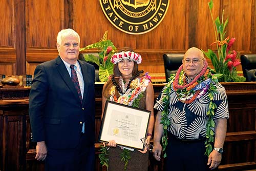 Hawaiʻi Supreme Court Chief Justice Mark Recktenwald, Fifth Circuit Court Documents Supervisor Lisa Kimura, and Administrative Director of the Courts Rodney Maile in front of the Hawaiʻi Supreme Court courtroom bench, 09/29/2023.