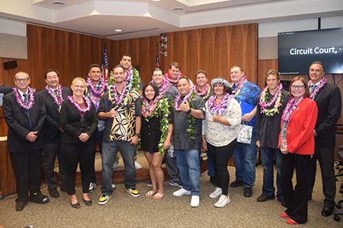 Maui judges and Drug Court graduates stand for a celebratory photo in the courtroom, 11-16-2023.