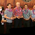 Standing in front of the bench of the Hawaii Supreme Court courtroom, holding their Spirit of Justice Award monkeypod bowls, from left: Legislative Coordinating/Special Projects Office Special Projects Coordinator Karen Takahashi, Legislative Coordinating/Special Projects Office Legislative Office Assistant Lori Rutherford, Budget Administrator & Deputy Department Head Gary Teramae, Policy & Planning Department Head Tom Mick, Deputy Administrative Director of the Courts Brandon Kimura, Administrative Director of the Courts Rodney Maile, and Chief Justice Mark Recktenwald, 10/25/2023.