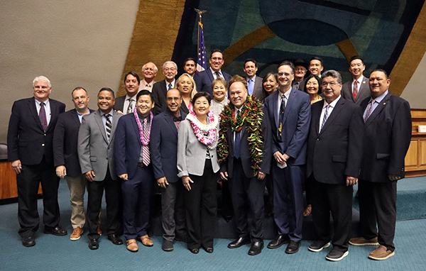 Image of Lisa Ginoza and Vladimir Devens, along with the Chief Justice and members of the Hawaiʻi State Senate.