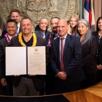 Gov. Josh Green holds a signed proclamation in the Governor's Office ceremonial room, joined by 12 Judiciary personnel, May 24, 2024.