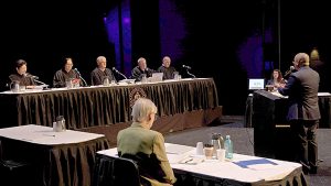 Hawaiʻi Supreme Court Associate Justice Lisa M. Ginoza, Associate Justice Sabrina S. McKenna, Chief Justice Mark E. Recktenwald, Associate Justice Todd W. Eddins, and Associate Justice Vladimir P. Devens at the bench, Hawaiʻi County Deputy Prosecuting Attorney Frederick M. Macapinlac at the podium, and attorney Georgette Anne Yaindl at the Petitioner's table. Courts in the Community at the University of Hawai‘i at Hilo Performing Arts Center, 04-17-2025.
