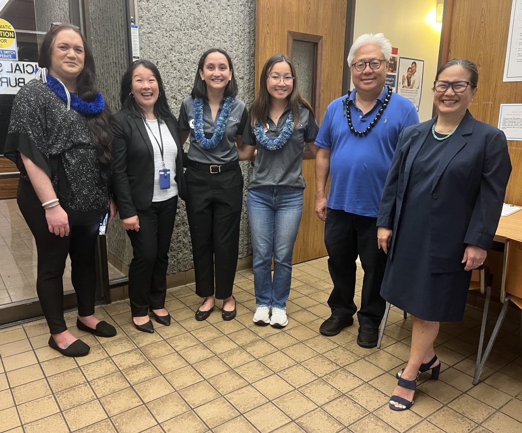 Volunteers from the Legal Aid Society and AmeriCorps pose with Judiciary personnel outside the Access to Justice room when it reopened in April 2025