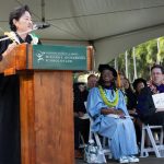 Hawaiʻi Supreme Court Associate Justice Lisa M. Ginoza stands behind a podium on stage at Andrew Amphitheater while delivering the keynote address to graduates of the University of Hawaiʻi William S. Richardson School of Law on May 18, 2025.