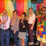 Representatives from the Hawaii State Judiciary and the Hawaii State Public Library Systems pose in frong of the Holoholo Bookmobile while parked at Lahaina District Courthouse.