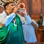 Veterans Treatment Court alumnus Joseph Quintero blows a conch shell to signal the start of the commencement ceremonies at the 2025 Hawaiʻi Drug Court, Veterans Treatment Court, and Mental Health Court Graduation.