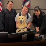Tuukka the courthouse dog visits a Family court courtroom in Kapolei and poses for a photograph with owner Jackie Hugger, District Family Judge Natasha Shaw and Court Clerk Mary Le.