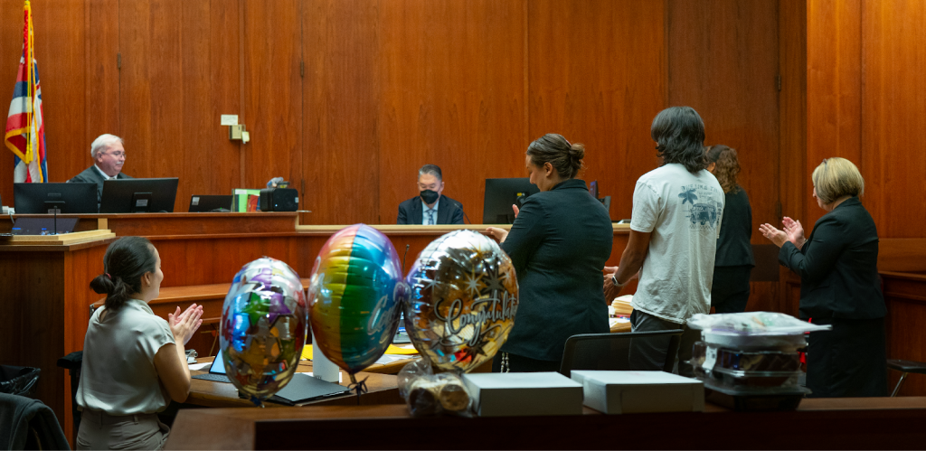 A DWI Court graduate is congratulated during his final hearing.