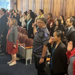 Attorneys stand with their right hand raised in the Hawaiʻi Supreme Court courtroom on Law Day, May 1, 2025, as they reaffirm their oath to support and defend the Constitution of the United States and the Constitution and laws of the State of Hawaiʻi.