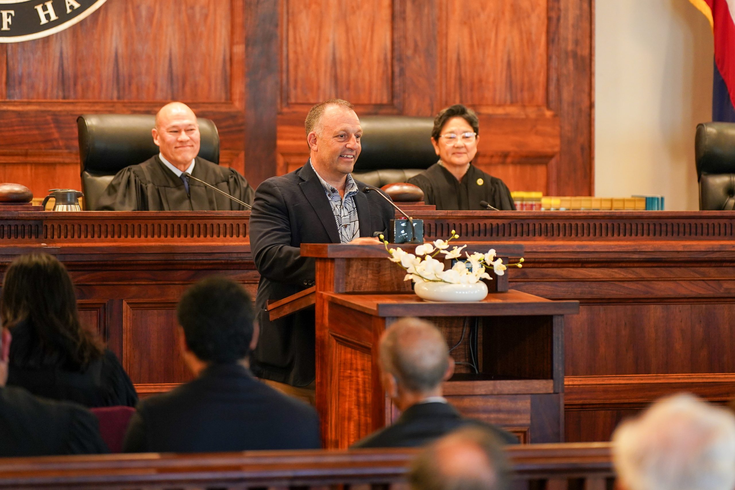 Governor Josh Green, who appointed Gluck to the Intermediate Court of Appeals, addresses family, friends, and members of Hawaiʻi's legal community during the swearing-in ceremony.