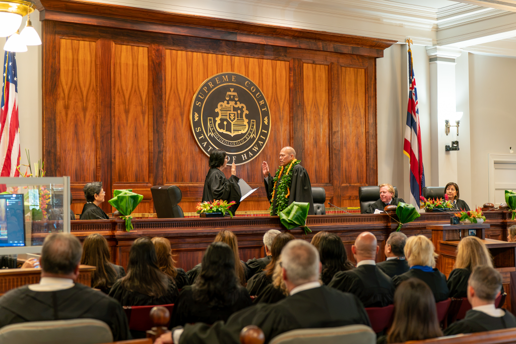 Associate Justice Sabrina S. McKenna administers the oath of office to Chief Justice Vladimir P. Devens during an investiture ceremony at Aliʻiōlani Hale on Aug. 3, 2026.