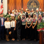 Current and former JDC judges, probation officers and team members pose in the Hawaiʻi Supreme Court courtroom at Aliʻiōlani Hale following the 25th anniversary celebration of the Juvenile Drug Court.